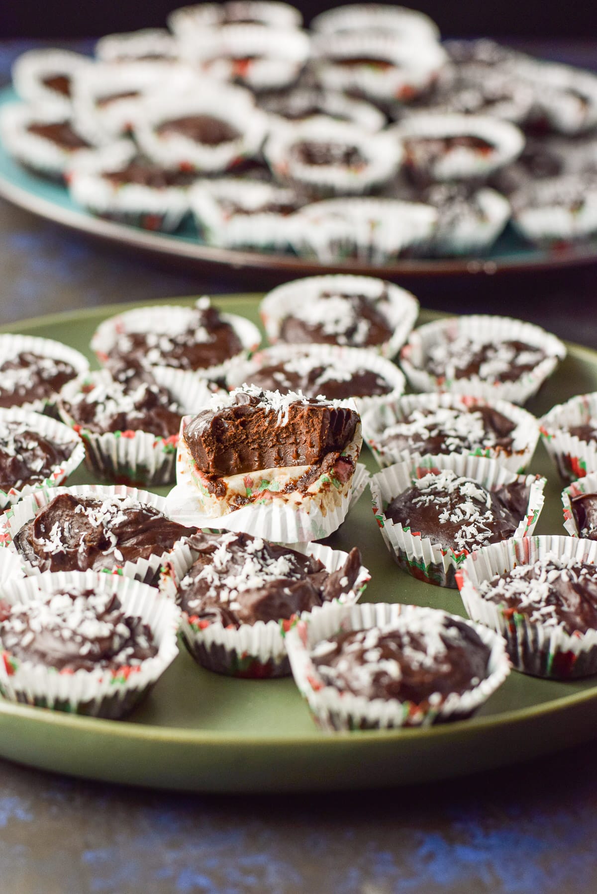 A truffle with a bite taken out of it on the plate of truffles