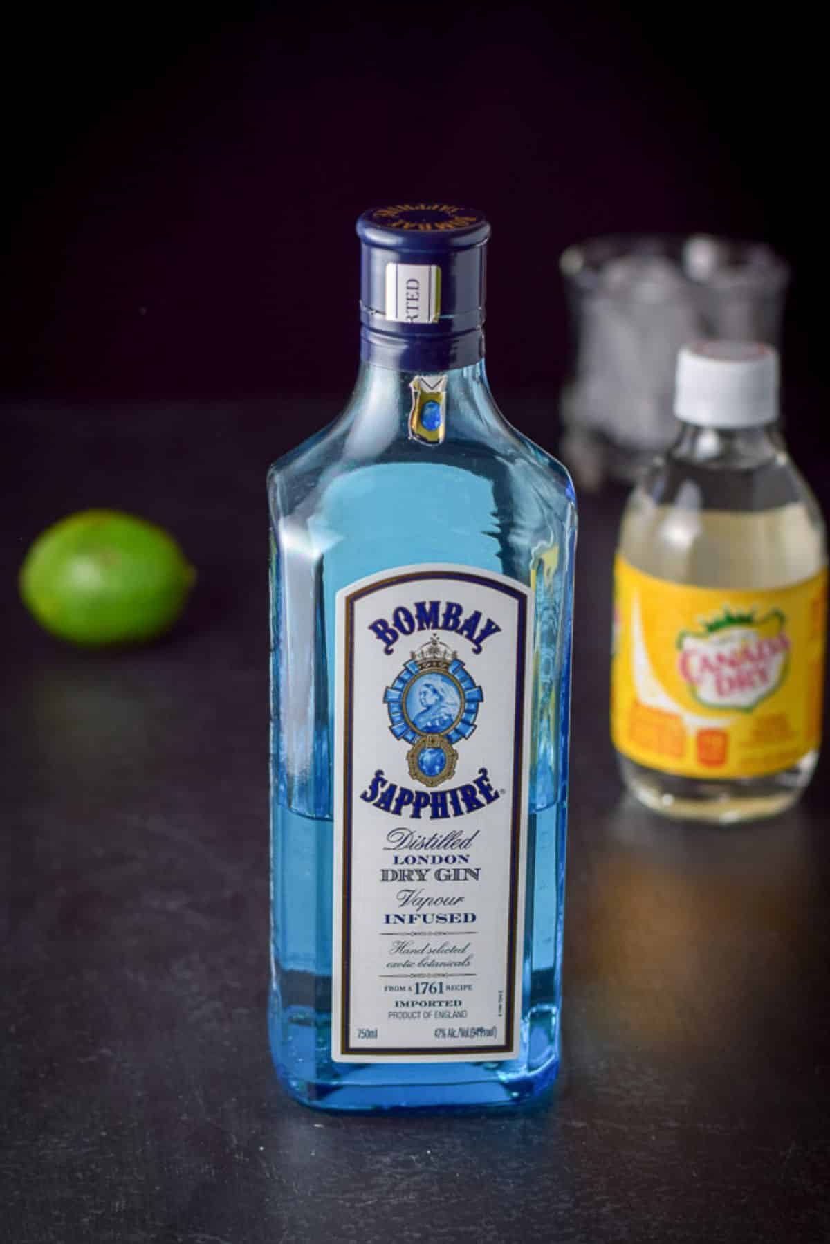 Gin, lime and tonic water with a glass filled with ice