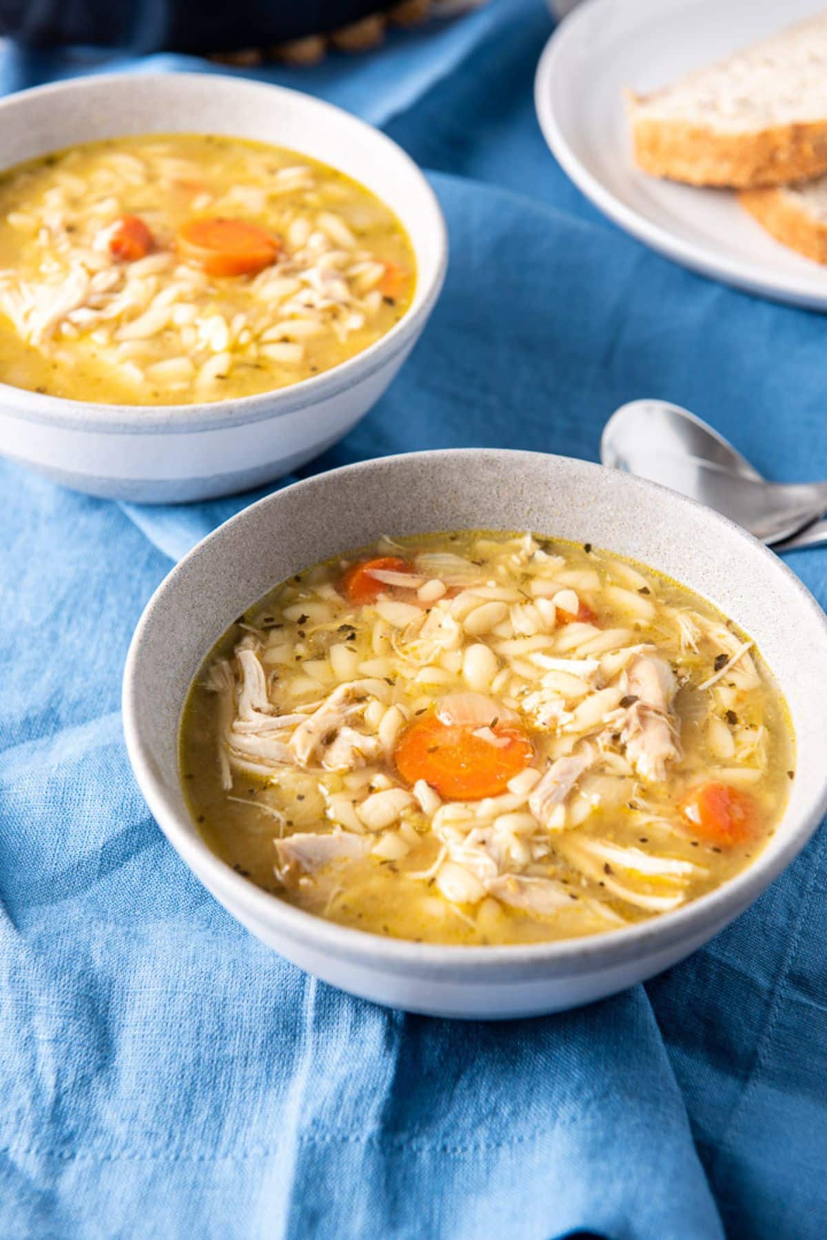 Higher view of the chicken soup in a bowl and on a blue napkin