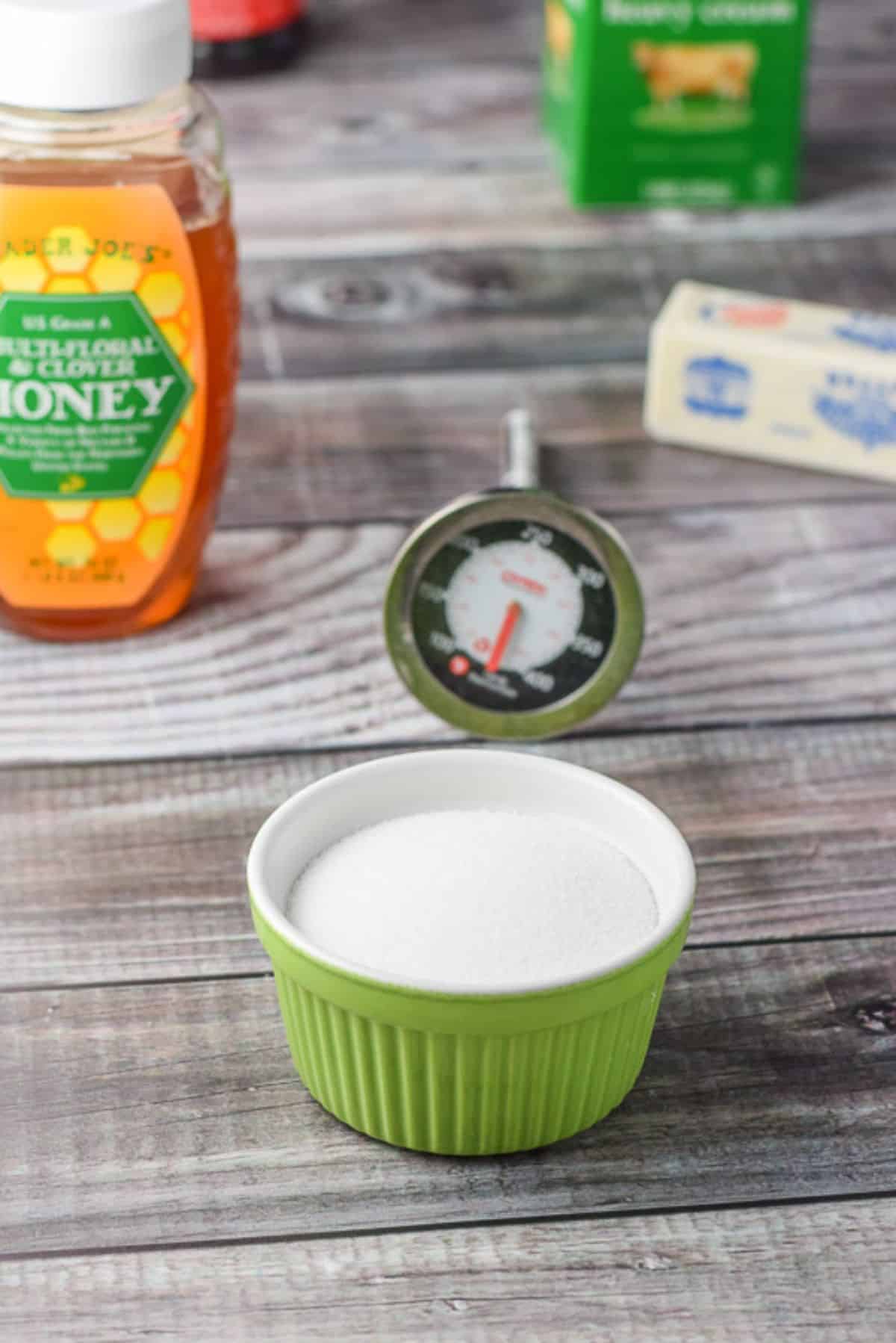 Sugar, honey, vanilla, butter and heavy cream on a grey table