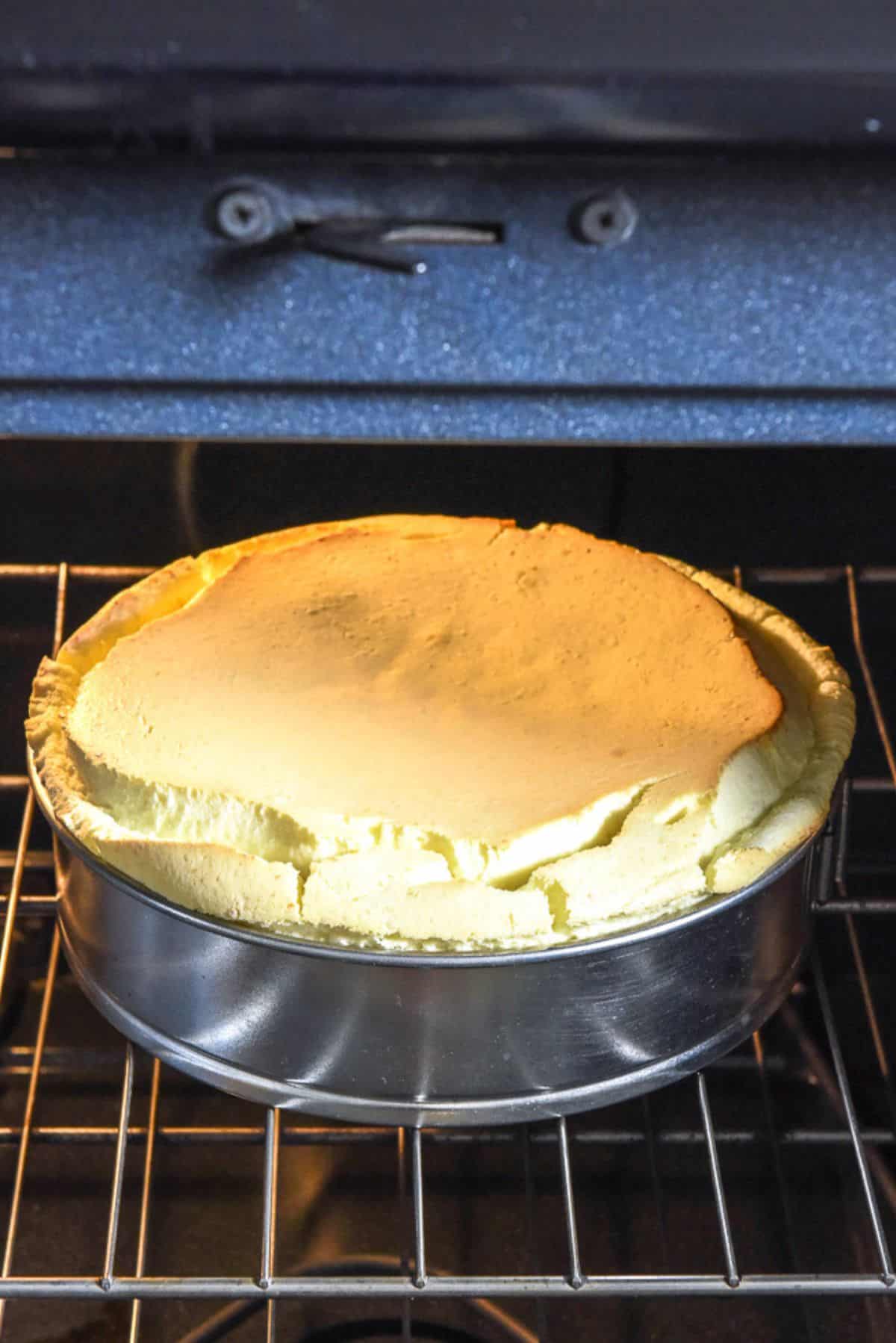 The cheesecake in the pan finished but still in the oven