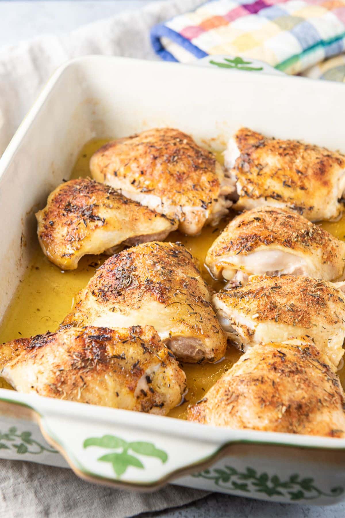 A baking dish filled with the roasted chicken thighs