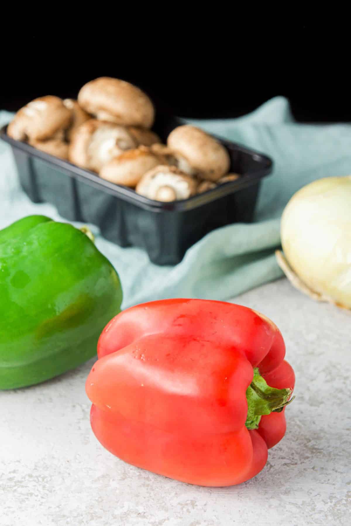 Peppers, onions, and mushrooms on the table