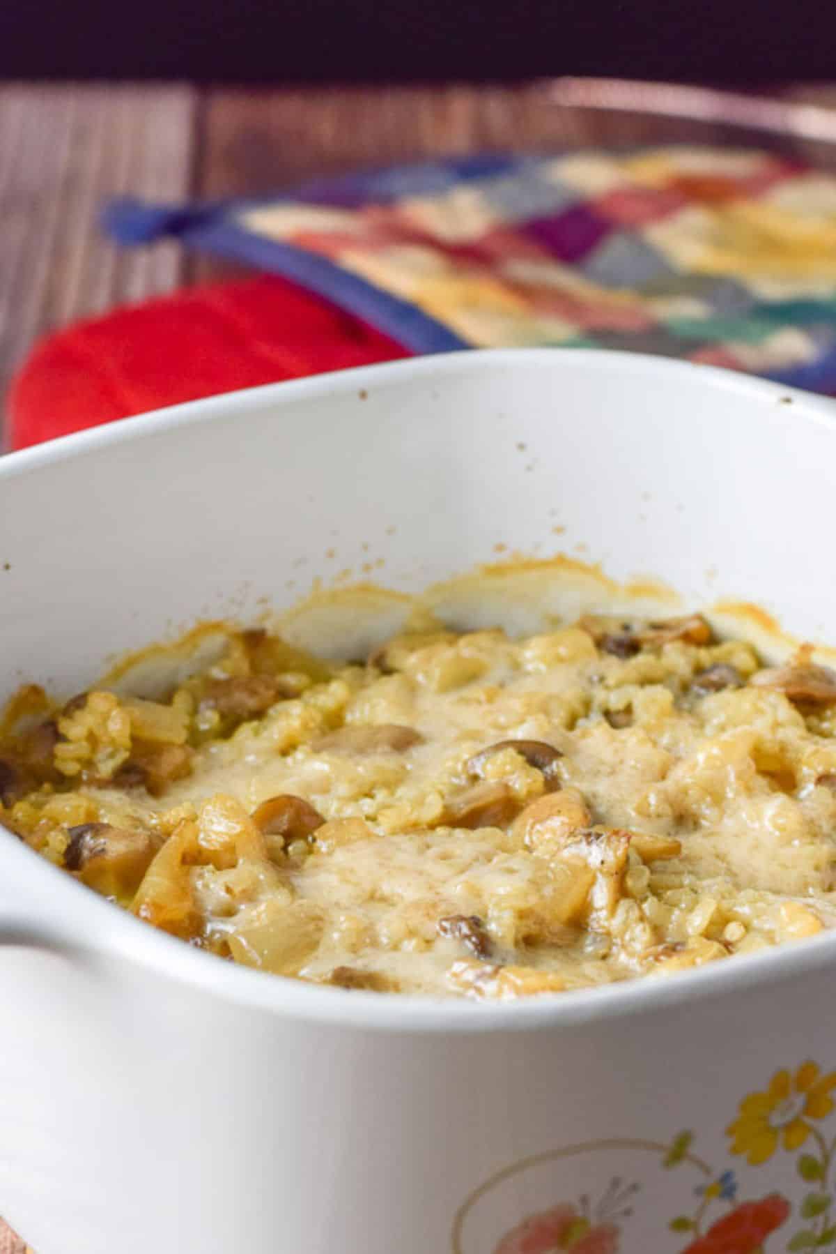 Melted parmesan cheese on the rice in the casserole dish straight out of the oven