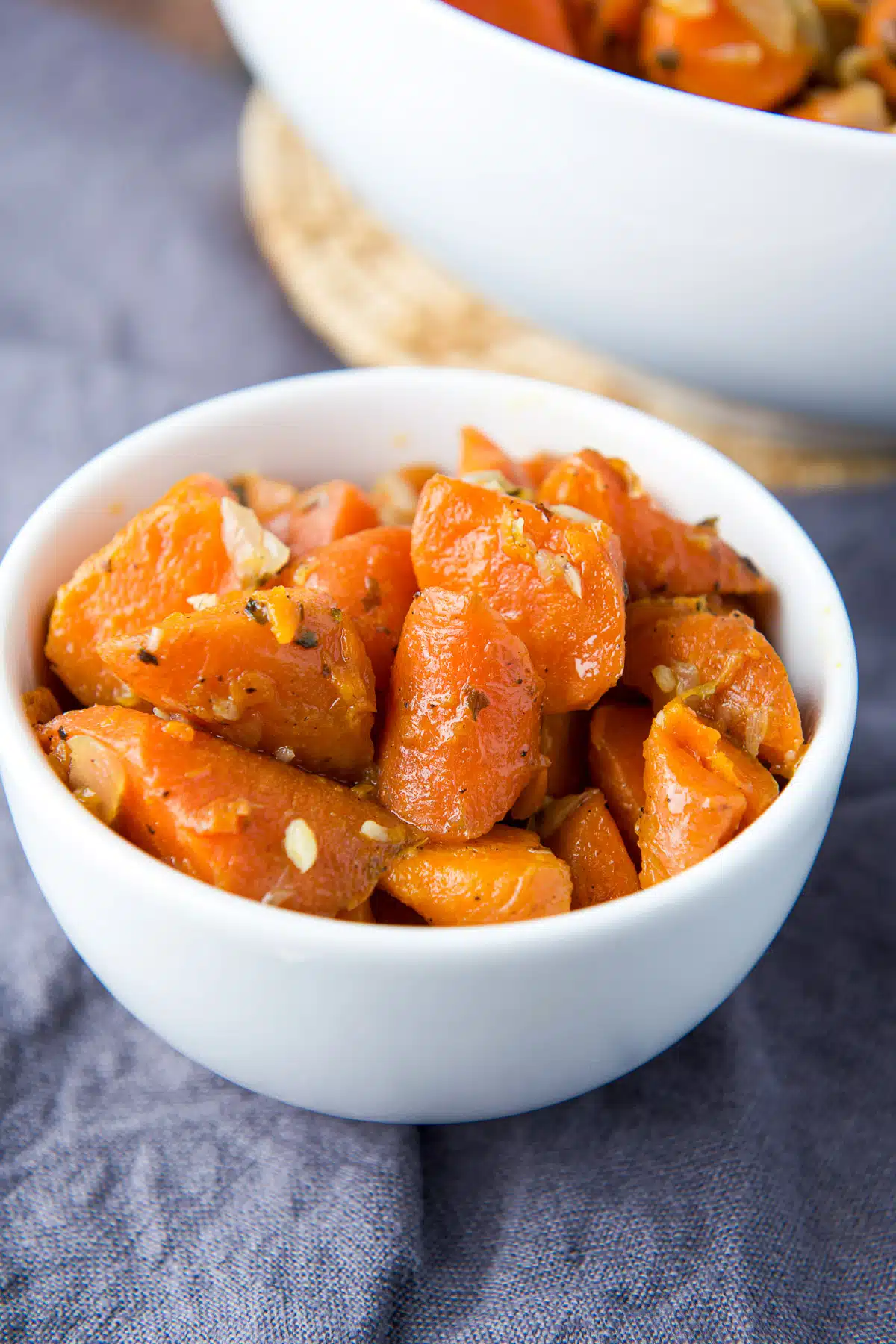 close up view of a small white bowl with carrots in it