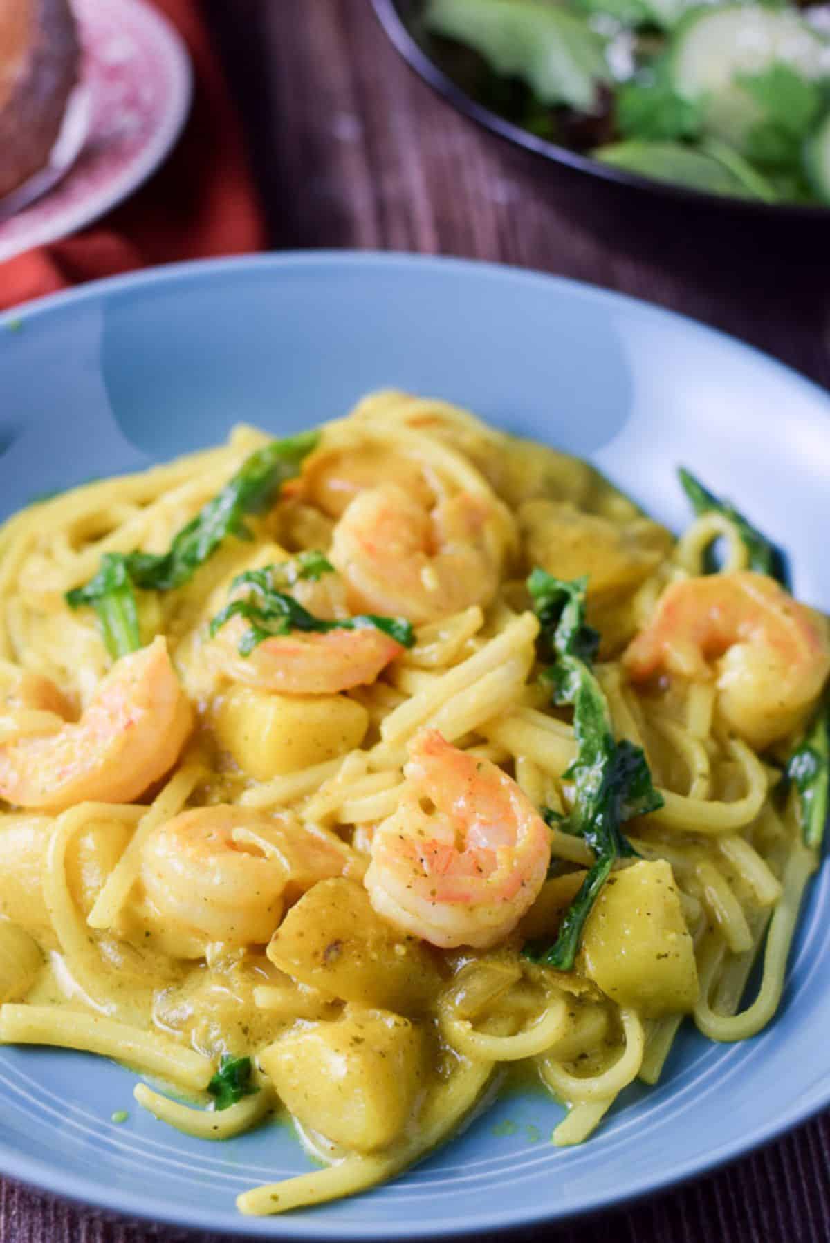 Closer view of the shrimp noodles in a blue deep plate