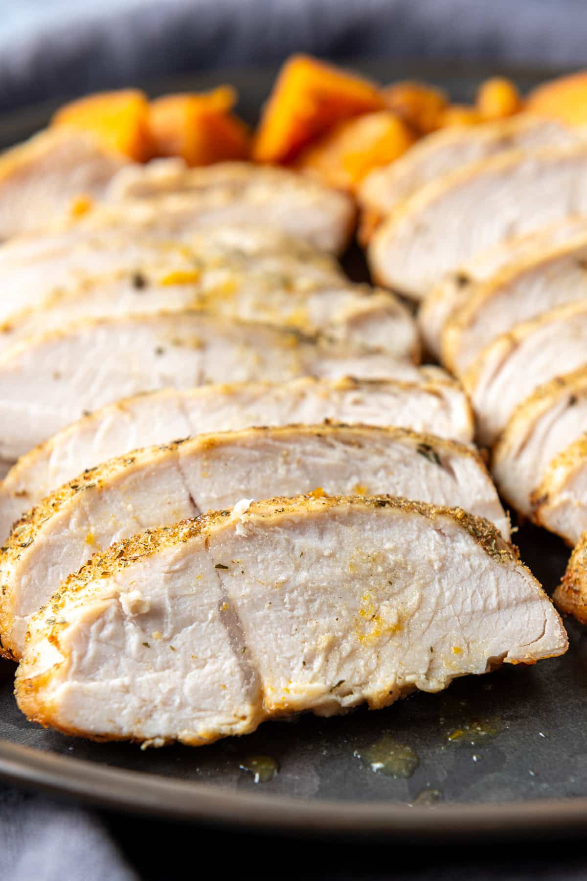 A metal plate with slices of turkey along with carrots