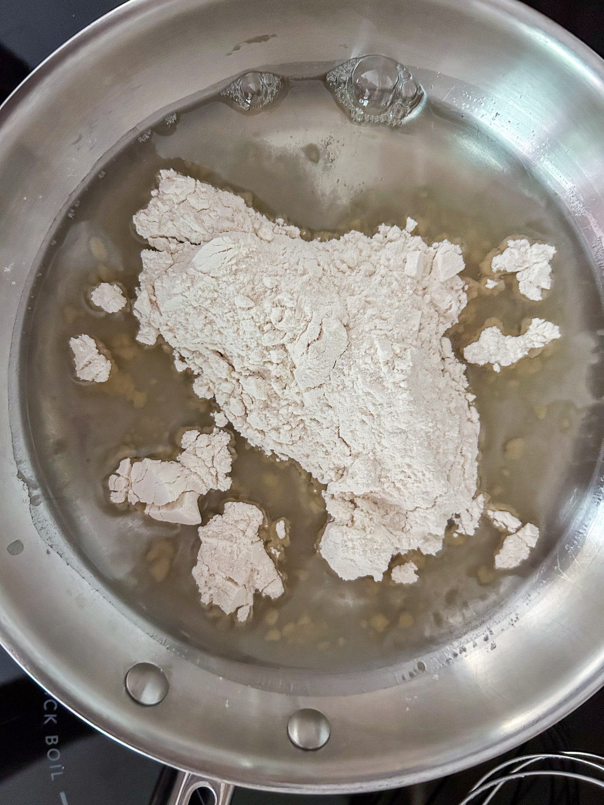 A pan with melted crisco and flour in it