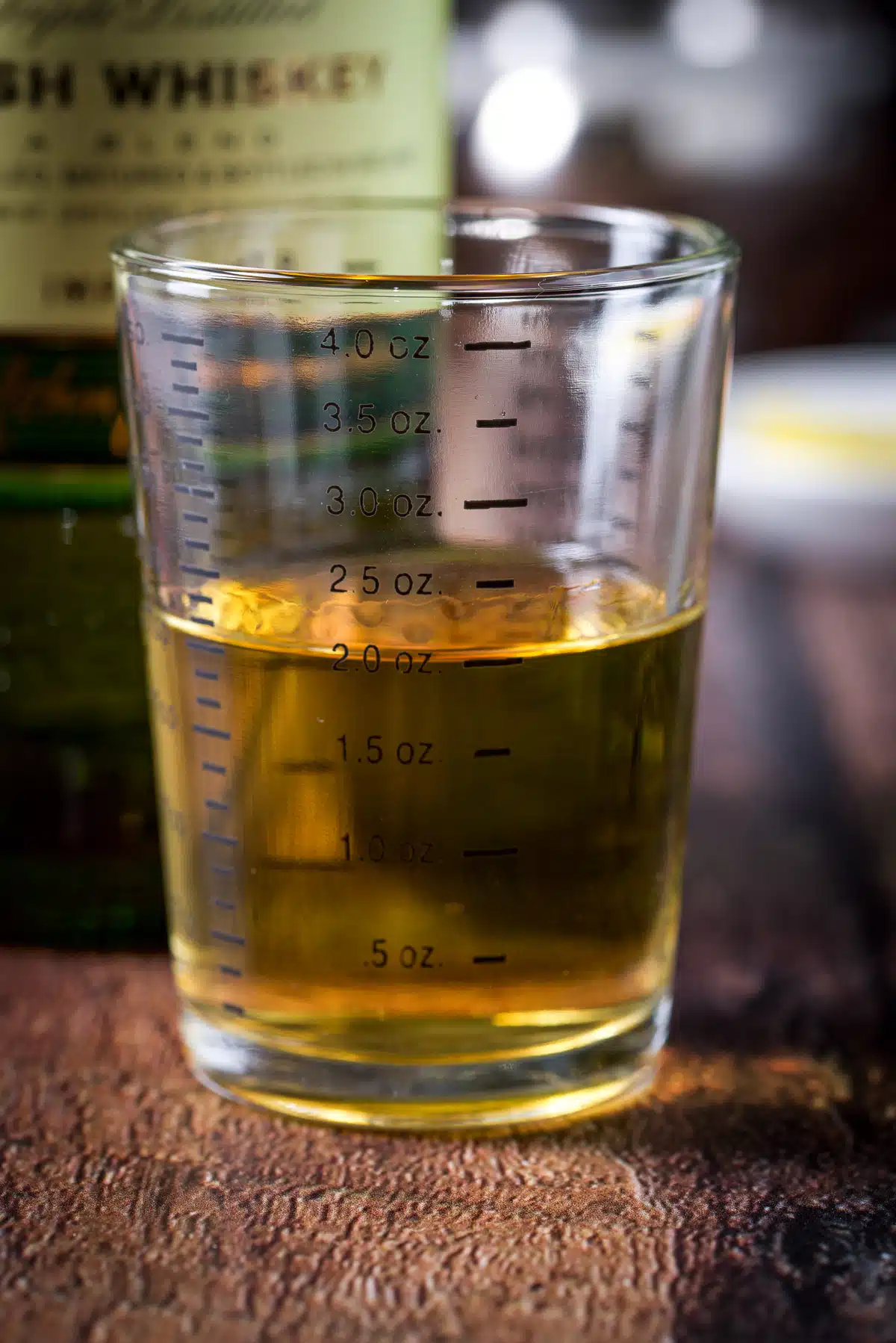 Whiskey measured out with the bottle in the back