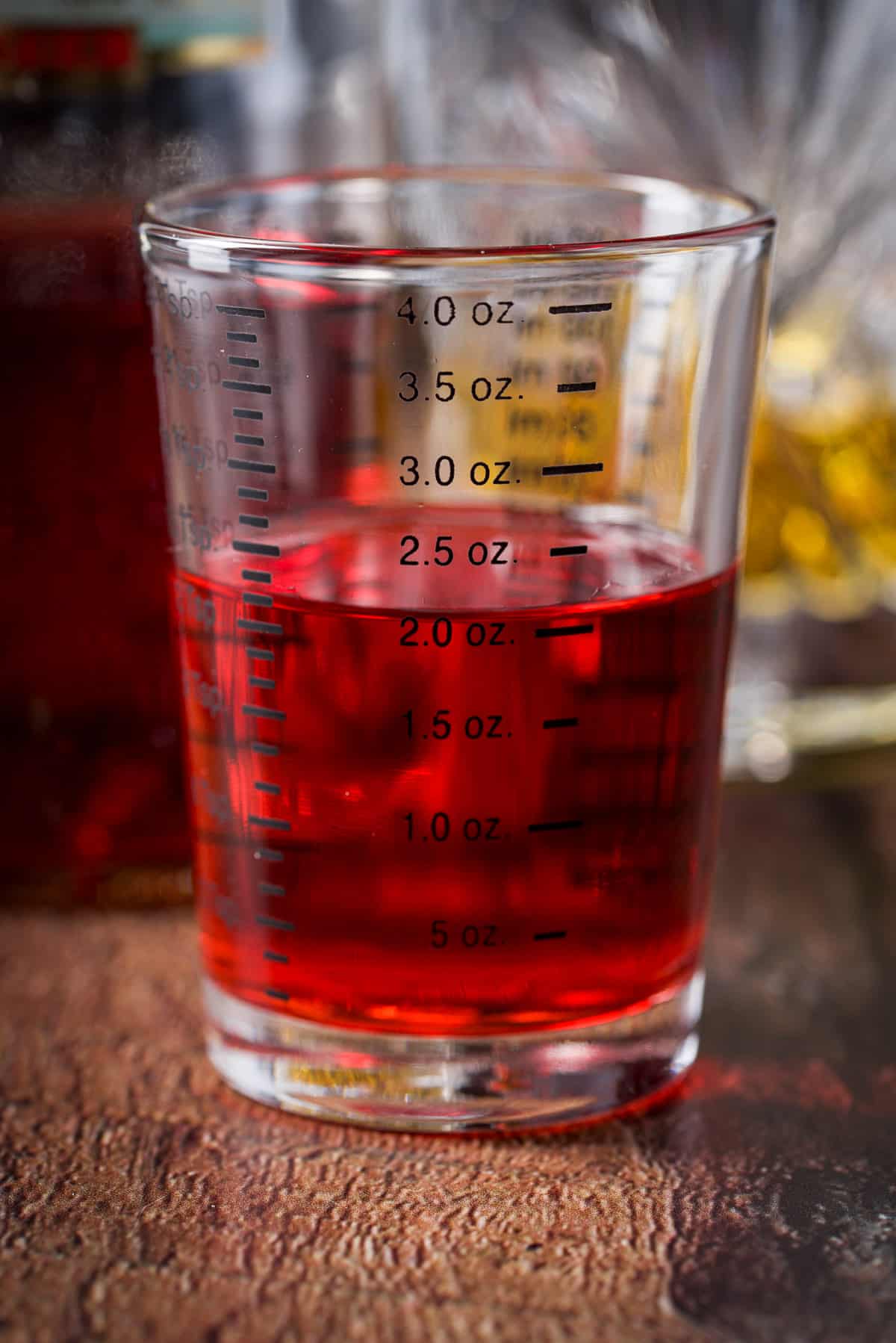 Campari measured out with the bottle behind it