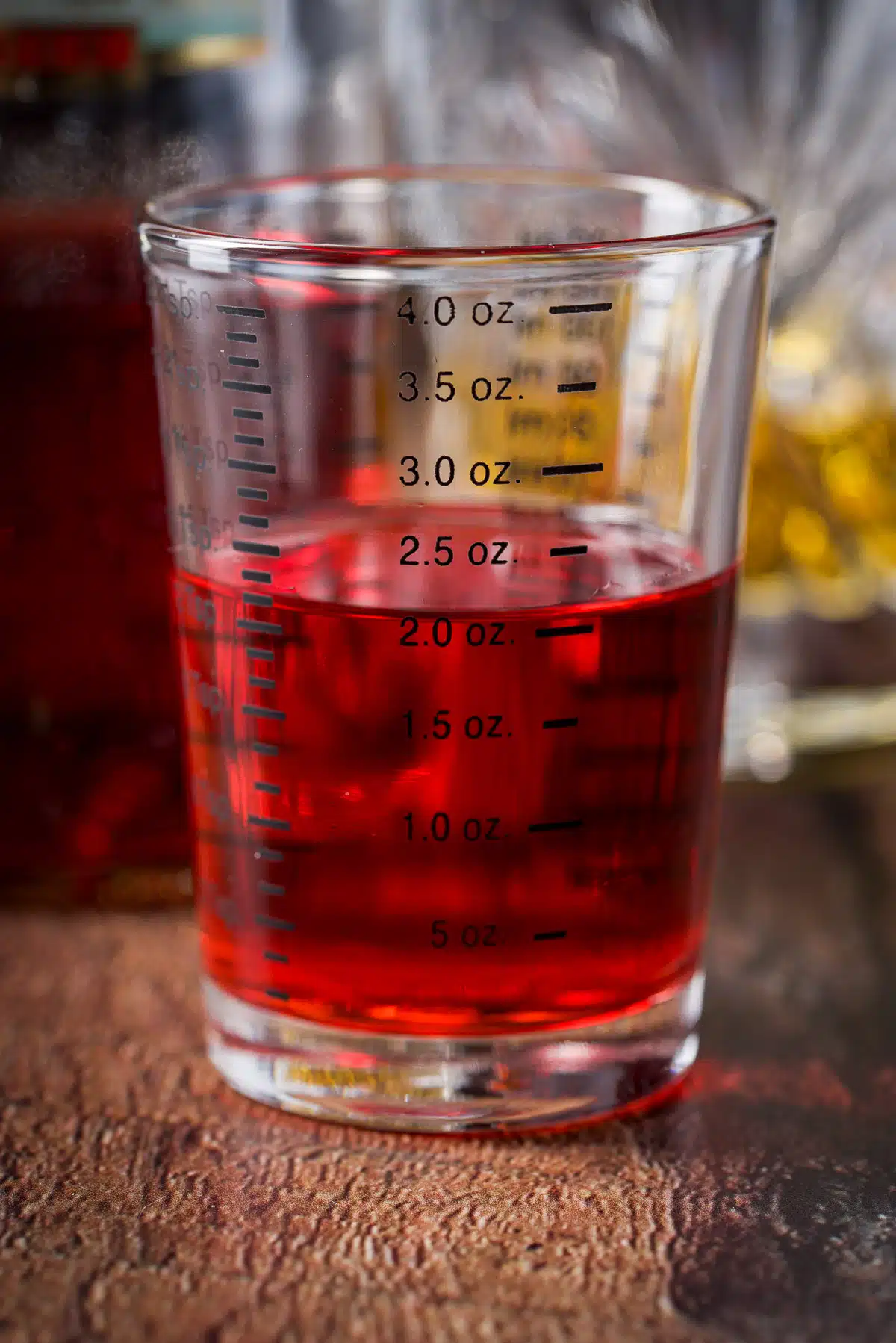 Campari measured out with the bottle behind it