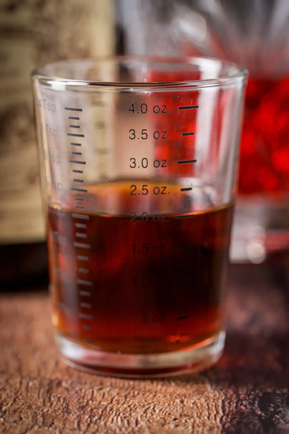 sweet vermouth measured out with the bottle in the back