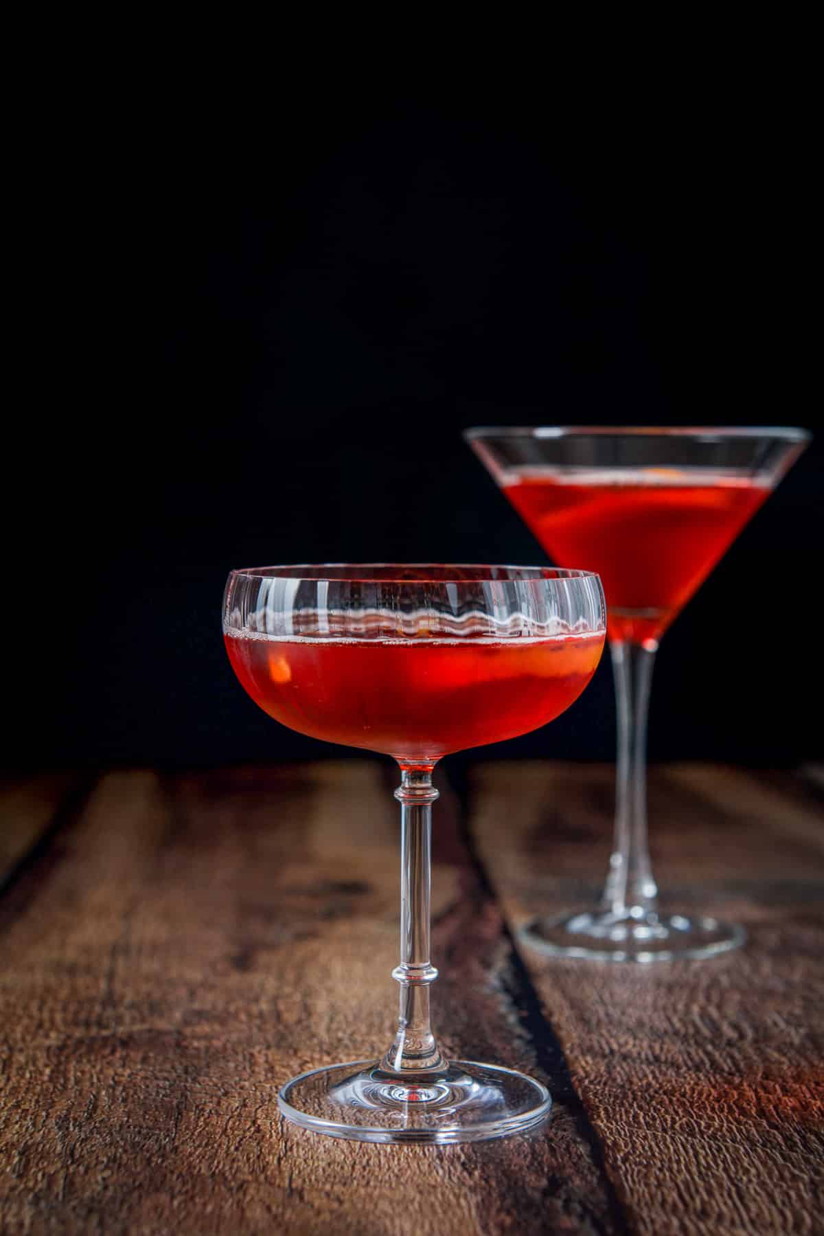 Vertical view of a coupe glass and martini glass with the boulevardier in it