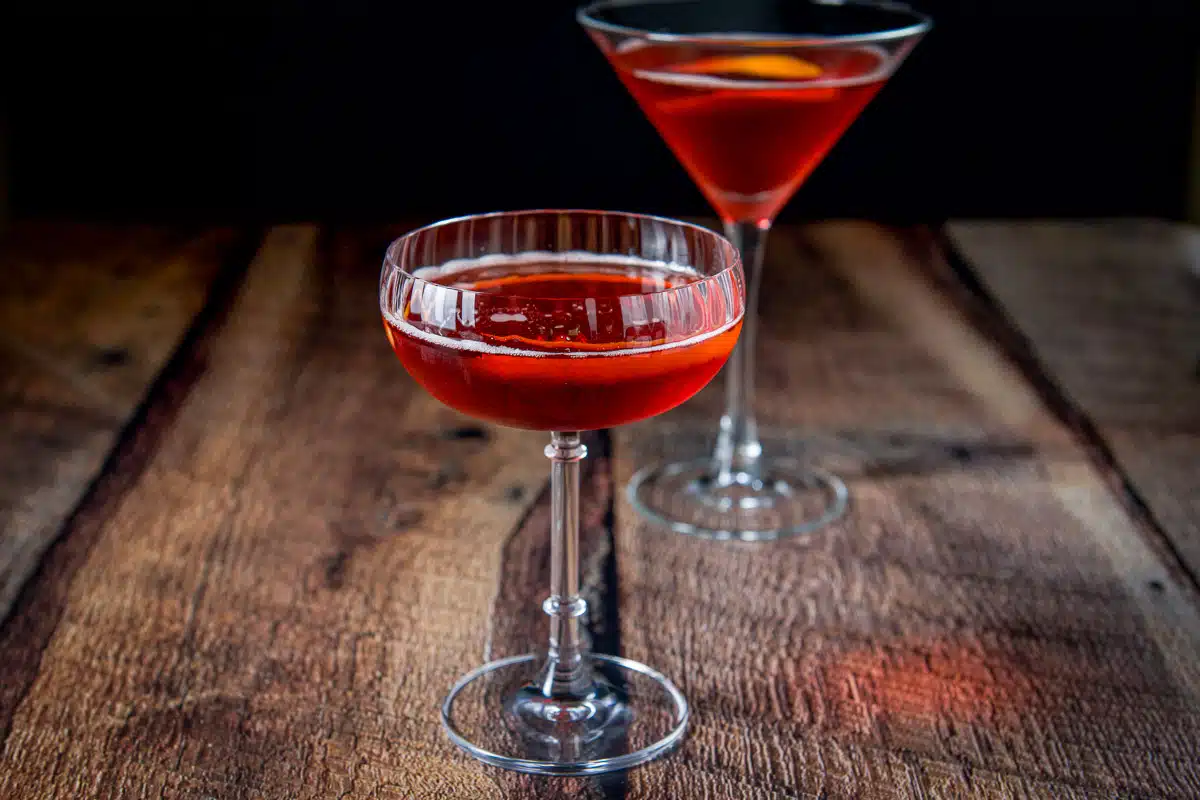 horizontal view of the boulevardier in it with twists as garnish