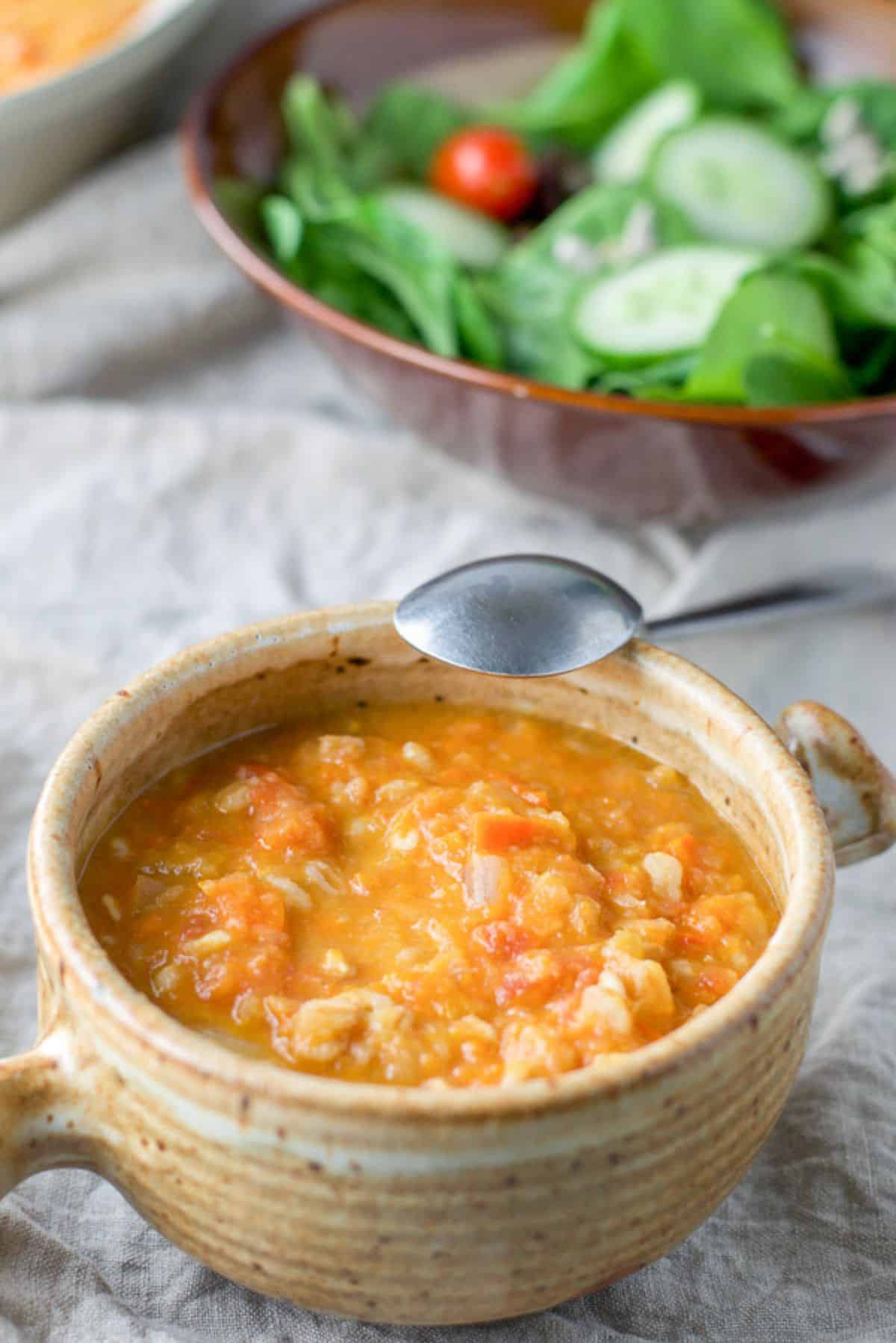 Close up of the crock of white bean soup and salad