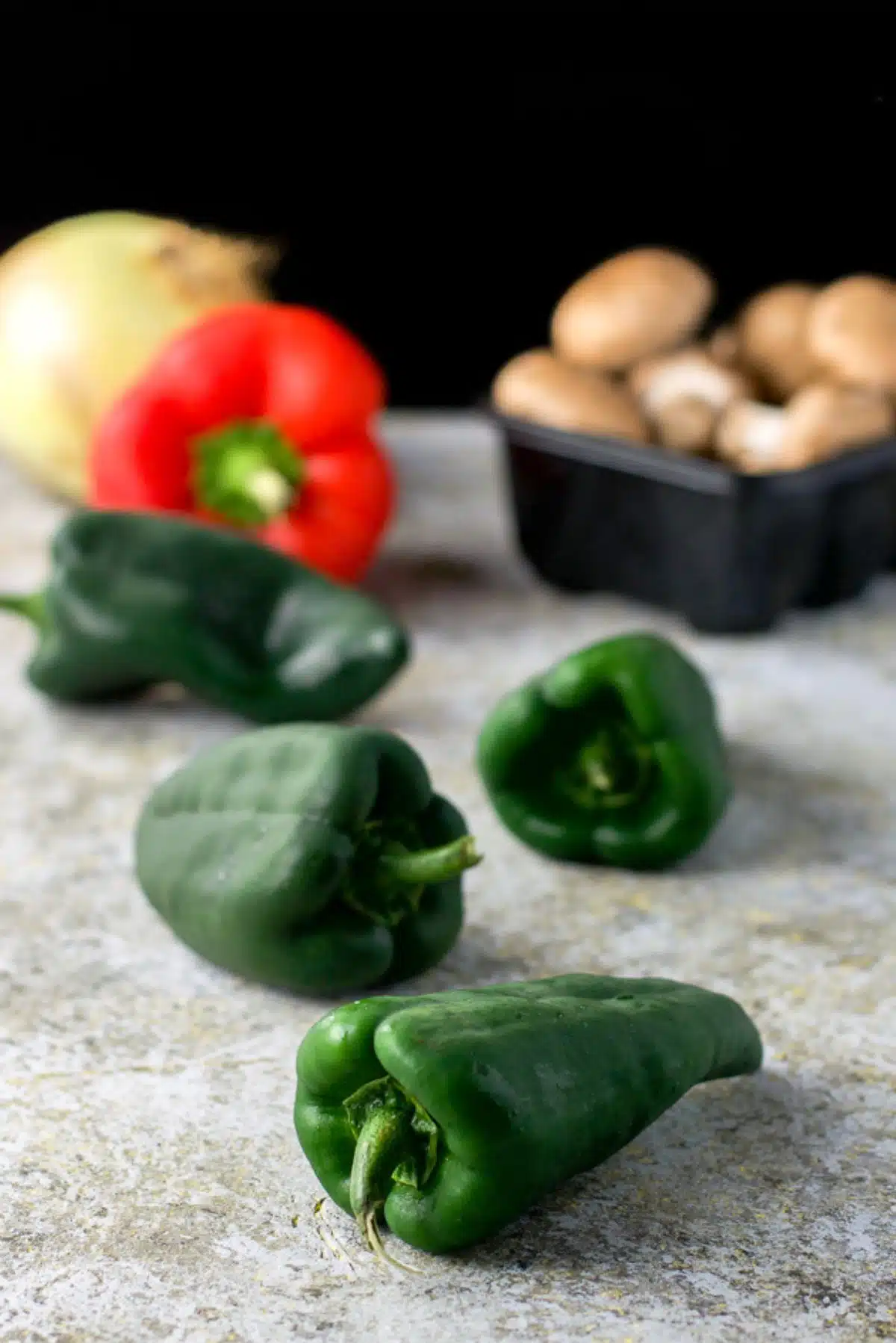 Anaheim peppers, onion and mushrooms on a colorful background