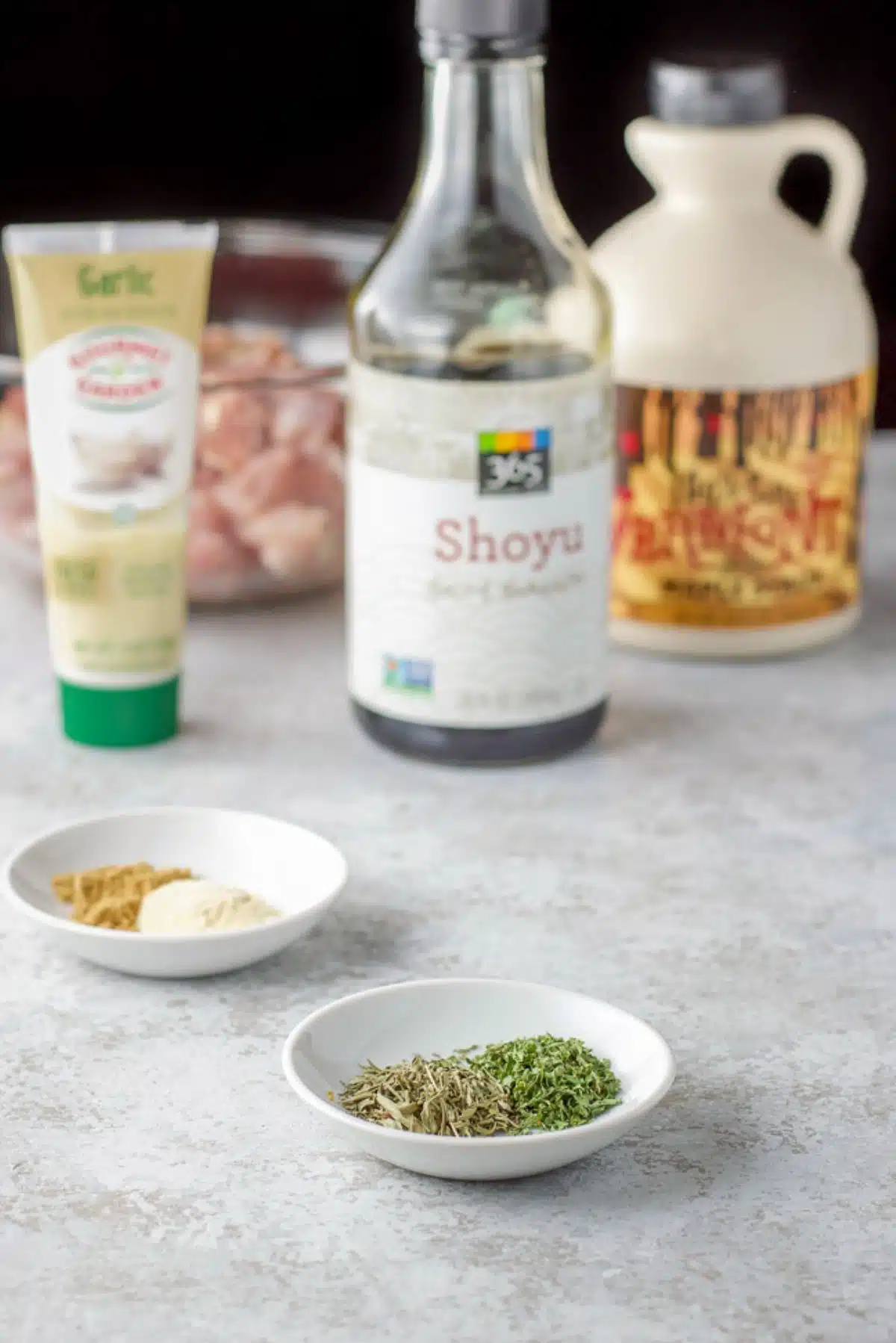 Herbs, spices, garlic paste, soy sauce, maple syrup, and chicken