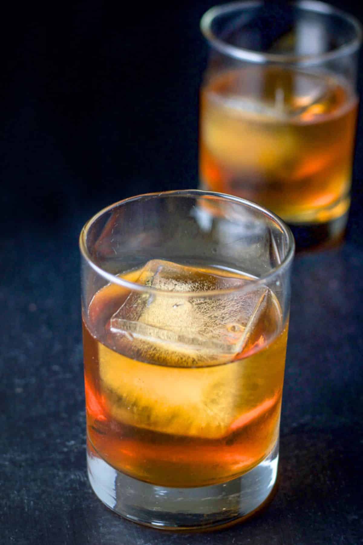 Close-up of two double old-fashioned glasses filled with the scotch drink