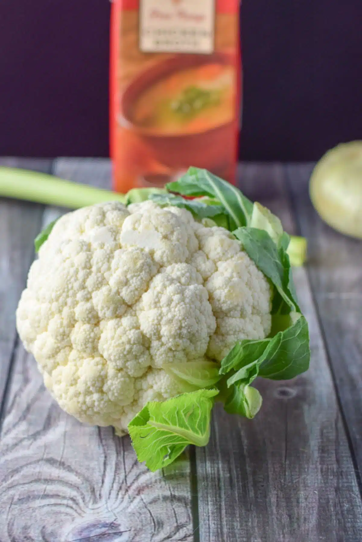 Cauliflower, onion, celery and chicken broth on the table